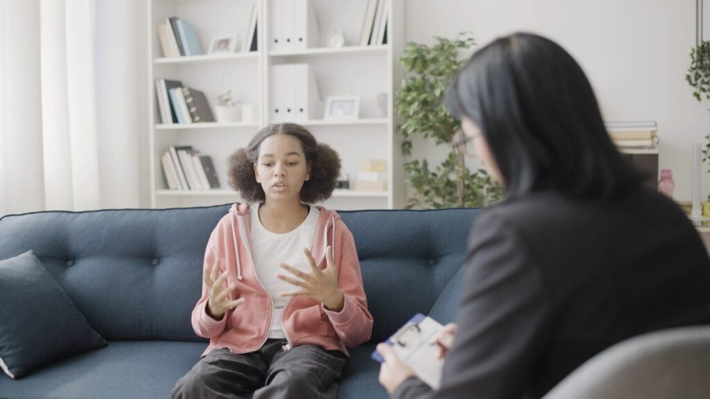 Teen girl talking to therapist about lying. 
